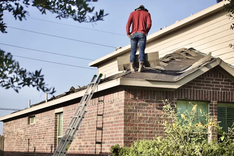Professional roofer working on a residential roof in Keeney Mill Farms